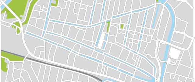 Grid of city streets, green spaces, and rivers