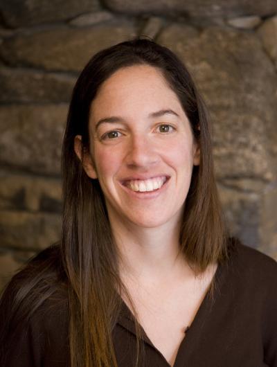 Headshot of Julie Zimmerman against brown background