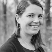 Black and white headshot of Amy Witt with trees in the background