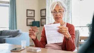 An old lady reading her medical prescription
