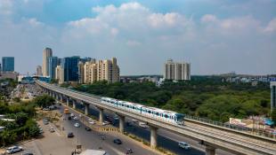 train over street with urban landscape in the background