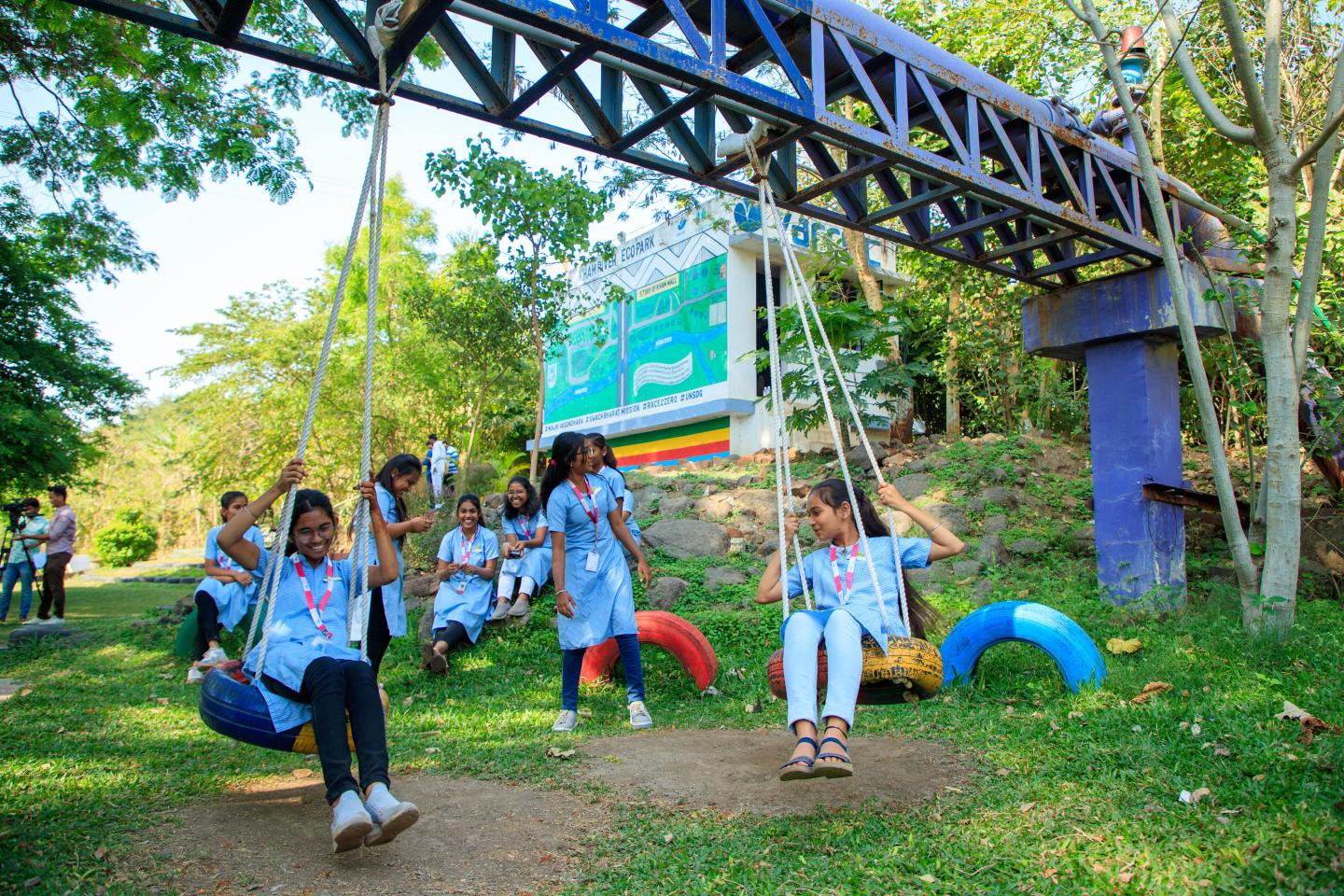 group of children playing in a pocket park with recycled materials