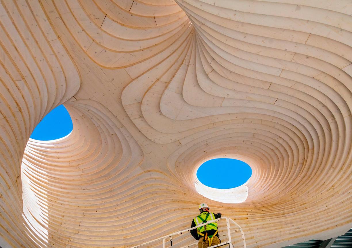 view of wooden ceiling with holes to blue sky