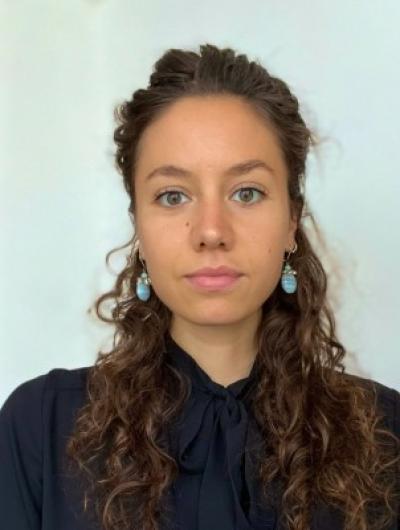 Headshot of Caroline Sgaglione in black blouse against white background
