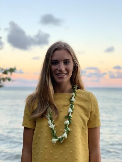 Headshot of Anelise Zimmer against a coastal Hawaii backdrop.