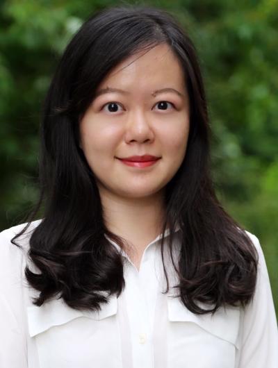 Headshot of  Xinyi Li against a green forested backdrop.