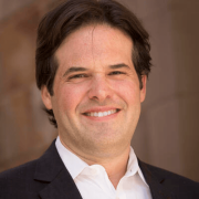 Headshot of David Schleicher against brown background