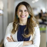 Headshot of Diana Fernandez Bibeau in a blue blouse and cream blazer