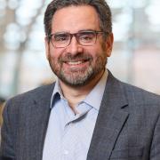 Headshot of Rob Klee in a blazer in Kroon Hall