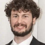 Headshot of Dexter Locke in black blazer against white background