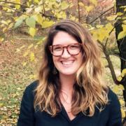 Headshot of Clara Pregitzer with fall foliage in the background