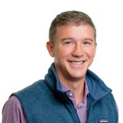 Headshot of Clint Myers in blue vest against white background