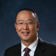 Headshot of David Kang against dark blue background