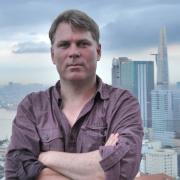Headshot of Erik Harms with NYC skyline in the background