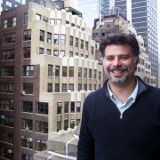 Headshot of Franco Montalto with skyscrapers in the background