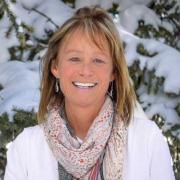 Headshot of Indy Burke with snowy trees in background