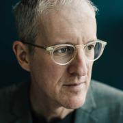 Headshot of Jeff Speck in a dark suite against a black background