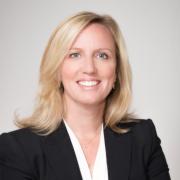 Headshot of Jodie McLean in blazer with white background