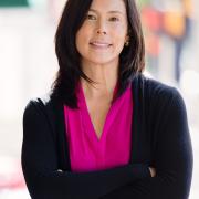 Headshot of Michelle Kondo in magenta blouse and dark blazer