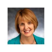 Headshot of Mary Northridge in turquoise blazer against black background