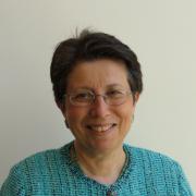 Headshot of Margaret Carreiro in turquoise cardigan