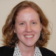 Headshot of Rebecca French against beige background