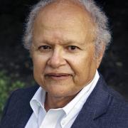 Headshot of Frank Snowden in dark suit against black background