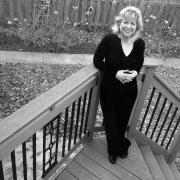Black and white photo of Suzanne Malec-McKenna on stairs in yard