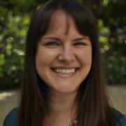 Headshot of Therese Dorau with foliage in the background