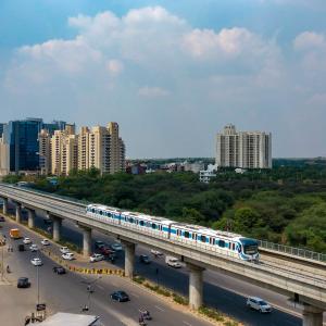 train over street with urban landscape in the background