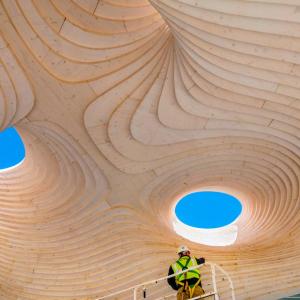 view of wooden ceiling with holes to blue sky